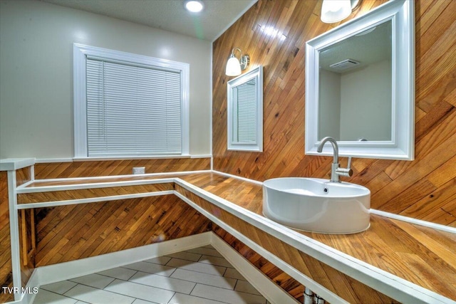542 Sigman Hollow Rd, Bluff City, TN 37618 - bathroom with tile patterned flooring and wood walls