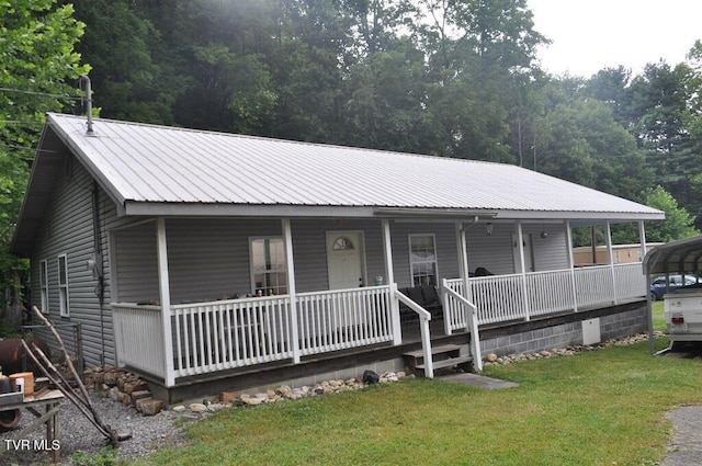 7125 Indian Creek Rd, Wise, VA 24293 - farmhouse inspired home featuring a porch, a front yard, a metal roof, and a carport