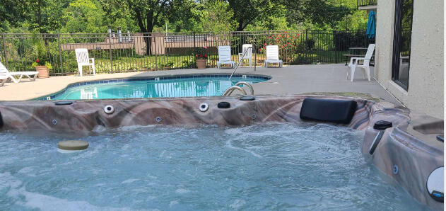 102 Baskins Creek Byp Unit 209, Gatlinburg, TN 37738 - community pool featuring a hot tub and a patio
