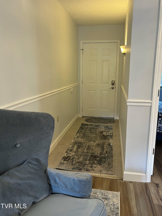 102 Baskins Creek Byp Unit 209, Gatlinburg, TN 37738 - doorway with wood finished floors and a textured ceiling