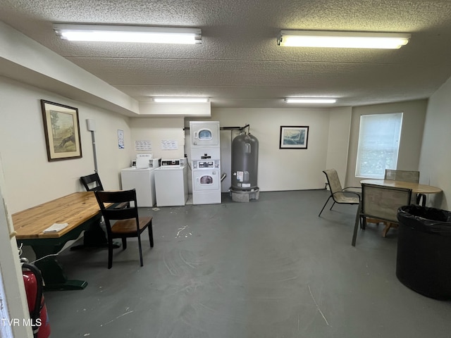 102 Baskins Creek Byp Unit 209, Gatlinburg, TN 37738 - home office featuring estacked washer and dryer, water heater, finished concrete floors, a textured ceiling, and independent washer and dryer