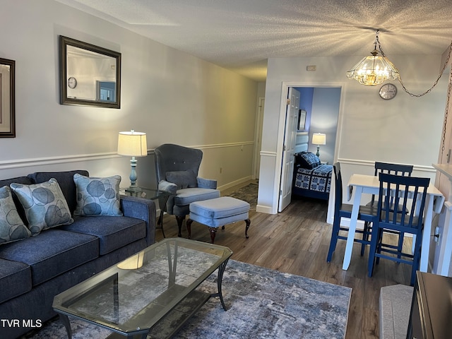 102 Baskins Creek Byp Unit 209, Gatlinburg, TN 37738 - living area featuring a chandelier, dark wood-type flooring, and a textured ceiling