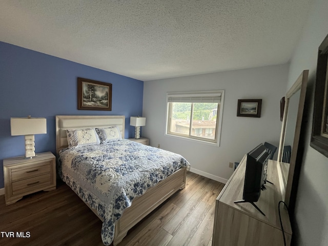 102 Baskins Creek Byp Unit 209, Gatlinburg, TN 37738 - bedroom with dark wood-type flooring and a textured ceiling