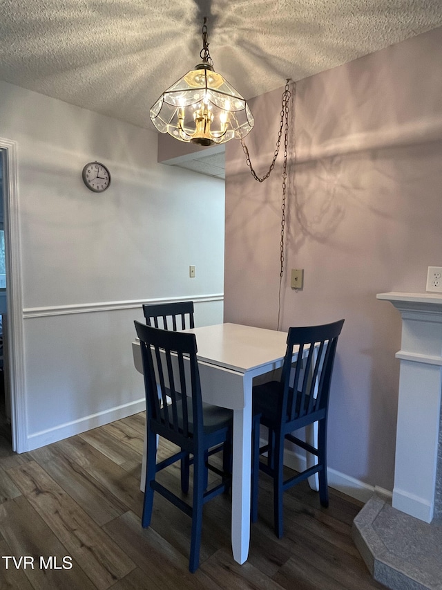 102 Baskins Creek Byp Unit 209, Gatlinburg, TN 37738 - dining room with a chandelier, a textured ceiling, and dark wood-type flooring