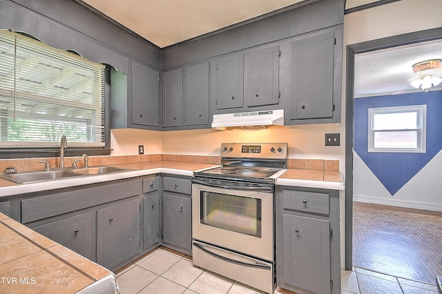 8822 Rich Valley Rd, Bristol, VA 24202 - kitchen featuring stainless steel electric range, under cabinet range hood, gray cabinetry, and light countertops