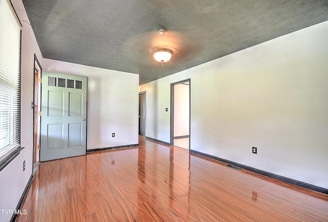 8822 Rich Valley Rd, Bristol, VA 24202 - unfurnished bedroom with wood finished floors, a textured ceiling, and a ceiling fan