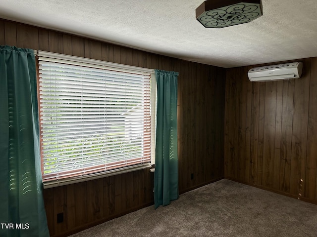 1277 Old Jonesboro Rd, Bristol, TN 37620 - empty room with an AC wall unit, wooden walls, a textured ceiling, and carpet floors