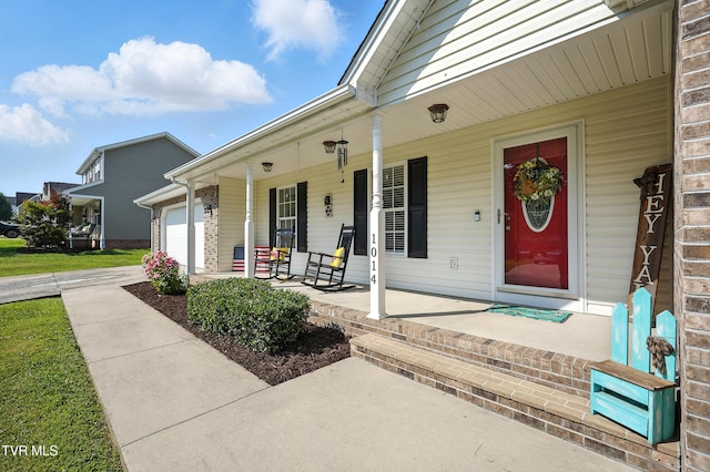 1014 Fox Meadow Cir, Bluff City, TN 37618 - property entrance featuring a porch, a garage, concrete driveway, and brick siding