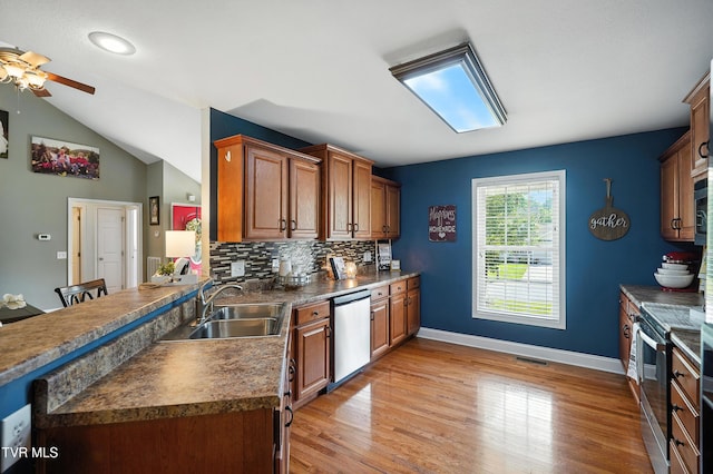 1014 Fox Meadow Cir, Bluff City, TN 37618 - kitchen with stainless steel appliances, ceiling fan, dark countertops, decorative backsplash, and light wood finished floors