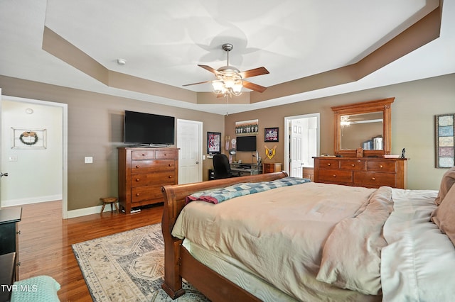 1014 Fox Meadow Cir, Bluff City, TN 37618 - bedroom featuring a raised ceiling, wood finished floors, a ceiling fan, a desk, and ensuite bath