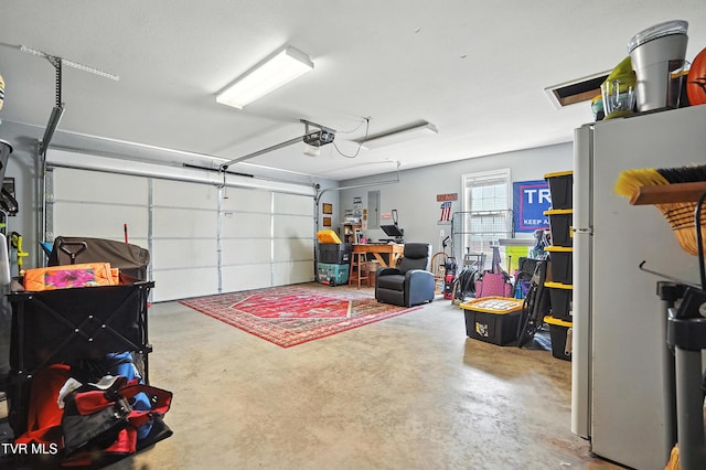 1014 Fox Meadow Cir, Bluff City, TN 37618 - garage featuring freestanding refrigerator and a garage door opener