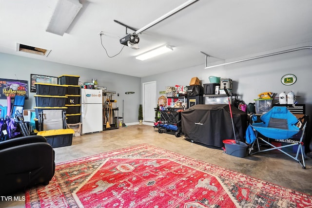 1014 Fox Meadow Cir, Bluff City, TN 37618 - garage featuring freestanding refrigerator and a garage door opener
