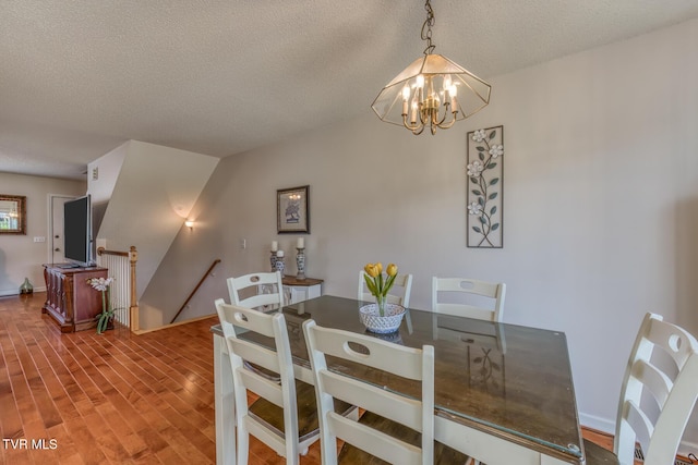 147 Rainbow Cir Unit 147, Bristol, VA 24202 - dining area with a chandelier, a textured ceiling, and wood finished floors