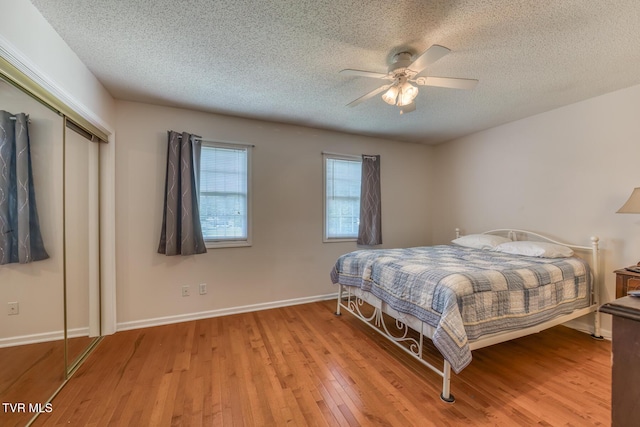147 Rainbow Cir Unit 147, Bristol, VA 24202 - bedroom featuring a textured ceiling, wood-type flooring, a closet, and a ceiling fan
