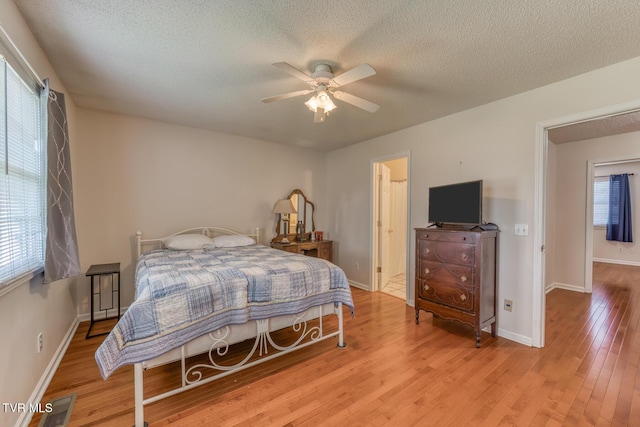 147 Rainbow Cir Unit 147, Bristol, VA 24202 - bedroom featuring light wood-style flooring, a textured ceiling, and a ceiling fan