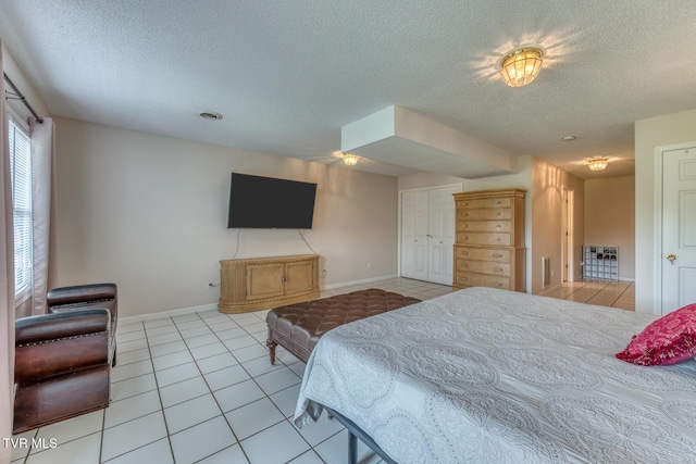 147 Rainbow Cir Unit 147, Bristol, VA 24202 - bedroom featuring light tile patterned floors, a textured ceiling, and a closet