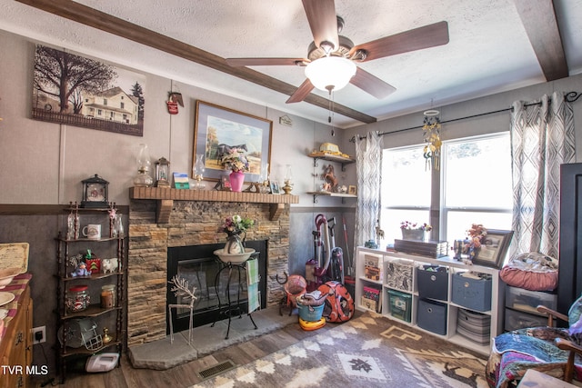 22720 Twin Oaks Rd, Abingdon, VA 24211 - living room with a textured ceiling, wood finished floors, a ceiling fan, and a stone fireplace