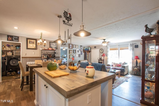 22720 Twin Oaks Rd, Abingdon, VA 24211 - kitchen featuring butcher block countertops, washing machine and dryer, dark wood-style floors, white cabinets, and pendant lighting