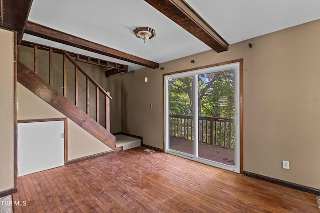285 Vanover Ln, Jacksboro, TN 37757 - unfurnished living room featuring beamed ceiling, hardwood / wood-style floors, and stairway