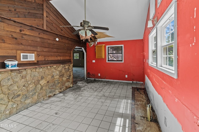 285 Vanover Ln, Jacksboro, TN 37757 - unfurnished room with wooden walls, ceiling fan, high vaulted ceiling, and arched walkways