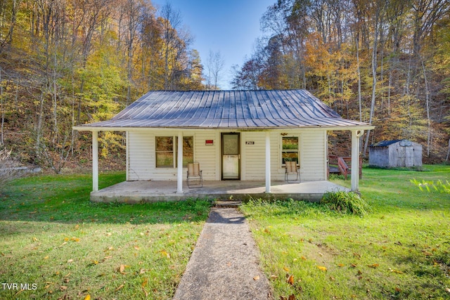 3961 Canton Rd, Blackwater, VA 24221 - view of front of home with a metal roof, a front yard, and a storage shed