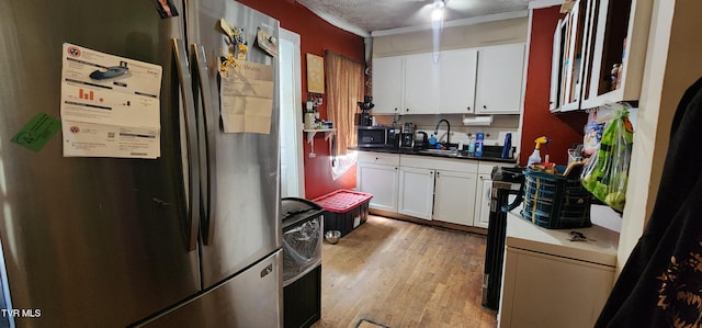 159 Millard St, Bristol, VA 24201 - kitchen featuring freestanding refrigerator, white cabinetry, light wood finished floors, and dark countertops