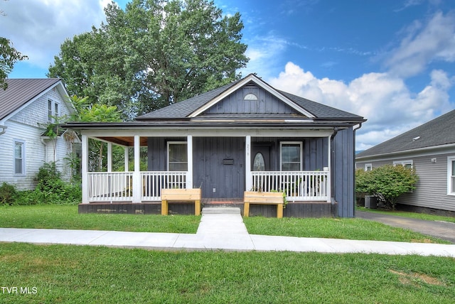 216 3rd St, Erwin, TN 37650 - view of front of home featuring covered porch, board and batten siding, a front lawn, and a shingled roof
