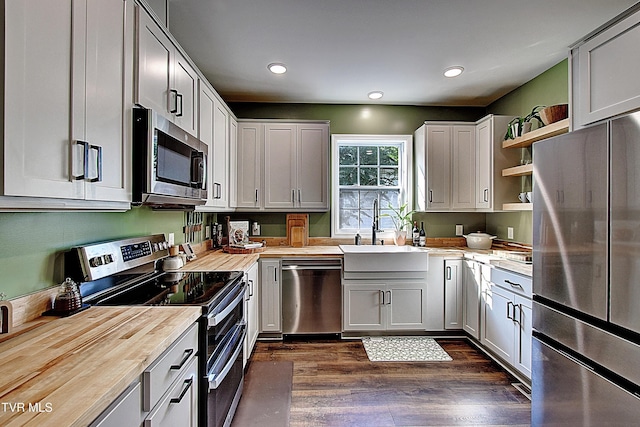 216 3rd St, Erwin, TN 37650 - kitchen with stainless steel appliances, wooden counters, open shelves, dark wood finished floors, and recessed lighting