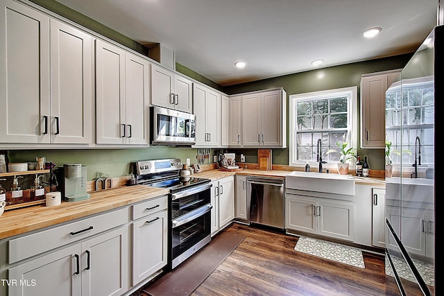 216 3rd St, Erwin, TN 37650 - kitchen with wooden counters, stainless steel appliances, dark wood finished floors, and recessed lighting