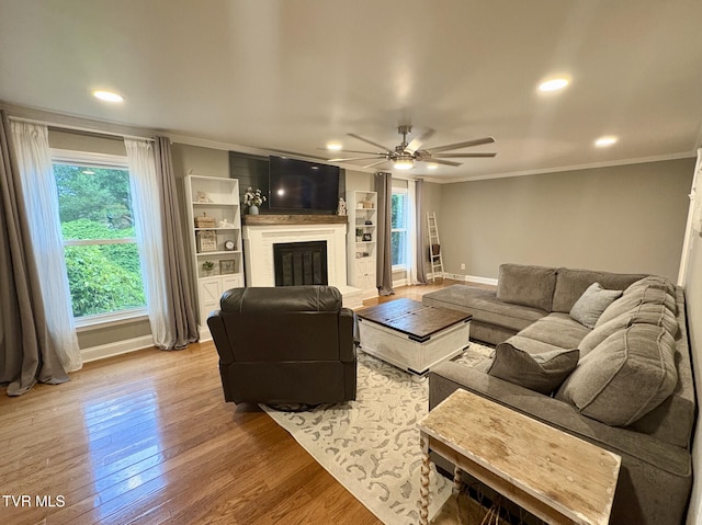 110 Galway Rd, Bristol, TN 37620 - living area featuring ornamental molding, plenty of natural light, a ceiling fan, a glass covered fireplace, and recessed lighting