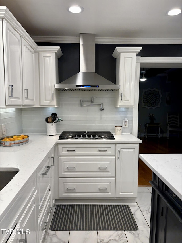 110 Galway Rd, Bristol, TN 37620 - kitchen featuring wall chimney range hood, stainless steel gas stovetop, white cabinets, crown molding, and backsplash
