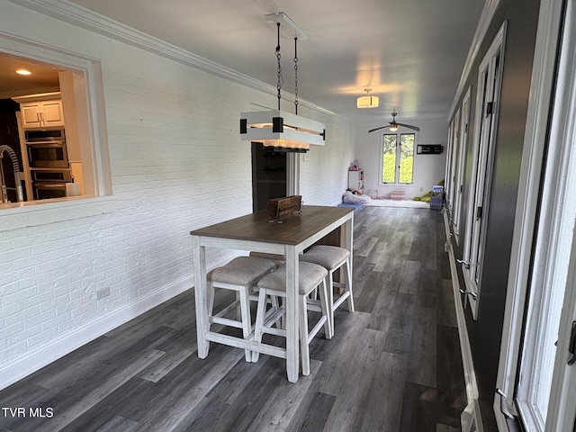 110 Galway Rd, Bristol, TN 37620 - dining room featuring brick wall, ceiling fan, dark wood-type flooring, and ornamental molding