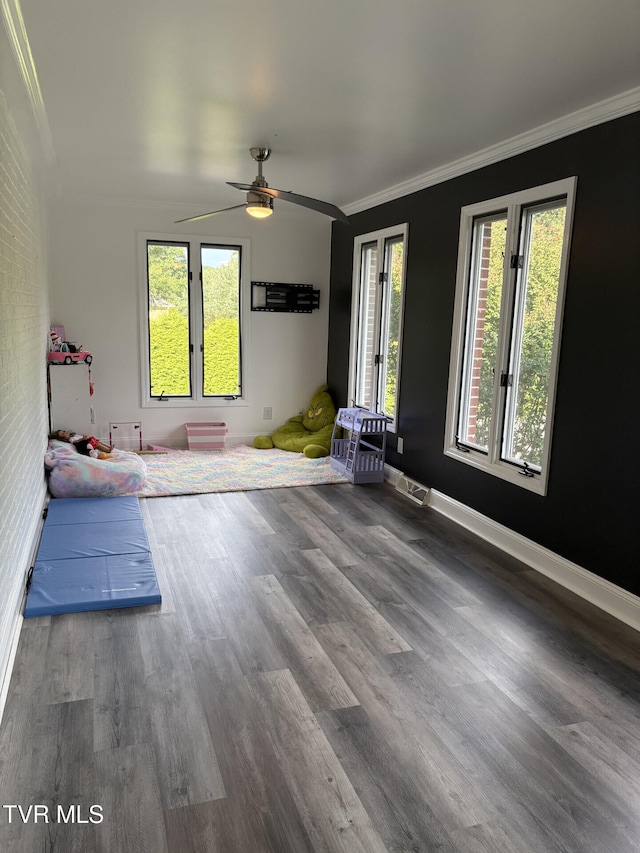 110 Galway Rd, Bristol, TN 37620 - unfurnished living room featuring ornamental molding, healthy amount of natural light, wood finished floors, and a ceiling fan