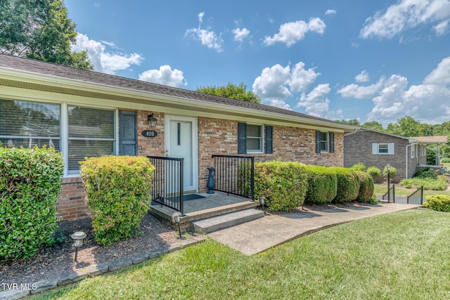 409 Brooklea Cir, Bluff City, TN 37618 - single story home featuring a front yard and brick siding