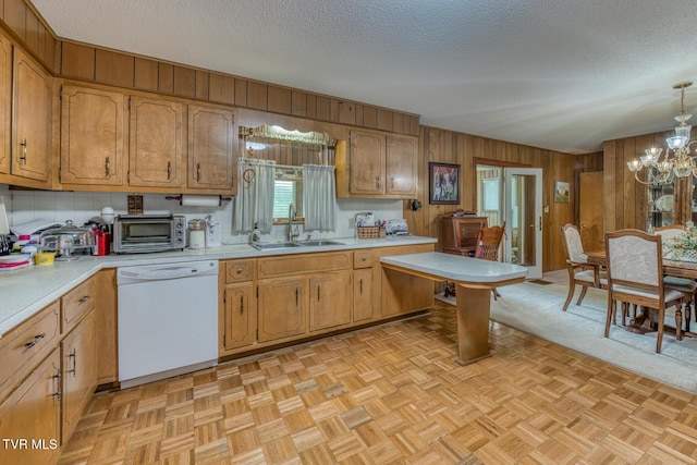 409 Brooklea Cir, Bluff City, TN 37618 - kitchen with white dishwasher, light countertops, a textured ceiling, a chandelier, and wooden walls