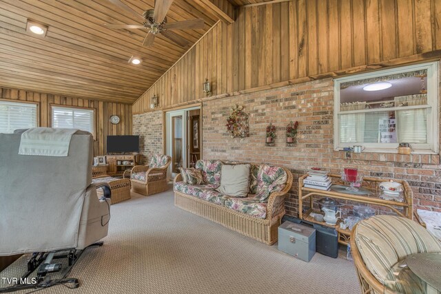 409 Brooklea Cir, Bluff City, TN 37618 - carpeted living room with wood ceiling, wooden walls, a ceiling fan, brick wall, and high vaulted ceiling