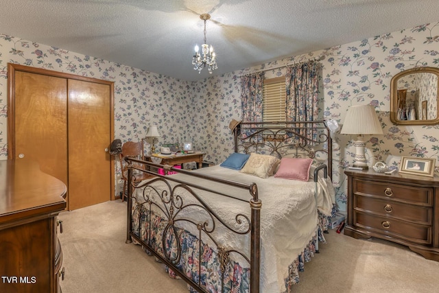 409 Brooklea Cir, Bluff City, TN 37618 - carpeted bedroom with wallpapered walls, a textured ceiling, and a chandelier