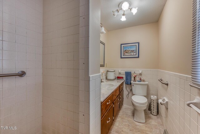 409 Brooklea Cir, Bluff City, TN 37618 - bathroom with vanity, wainscoting, tile patterned flooring, and tile walls