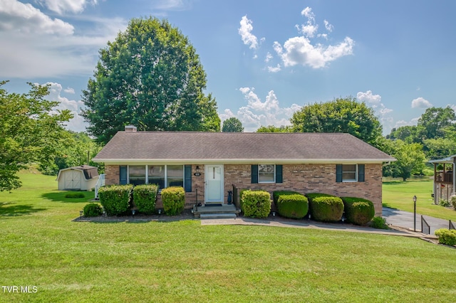 409 Brooklea Cir, Bluff City, TN 37618 - view of front facade with brick siding, a front lawn, a storage unit, a chimney, and a shingled roof