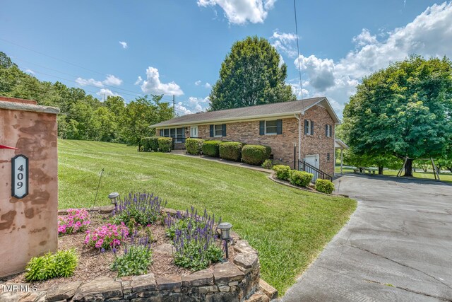 409 Brooklea Cir, Bluff City, TN 37618 - ranch-style home featuring asphalt driveway, an attached garage, a front lawn, and brick siding