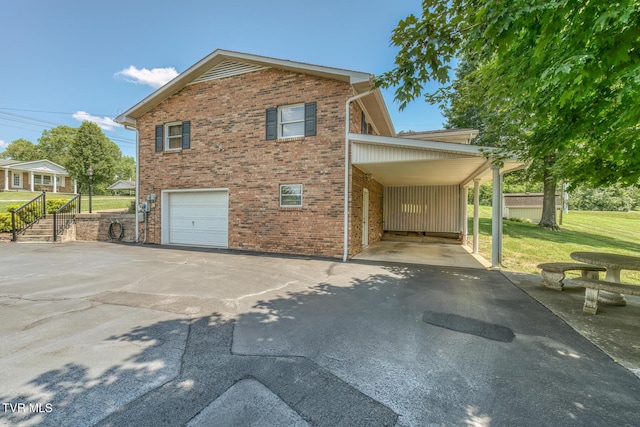 409 Brooklea Cir, Bluff City, TN 37618 - view of property exterior featuring asphalt driveway, brick siding, a lawn, and an attached carport