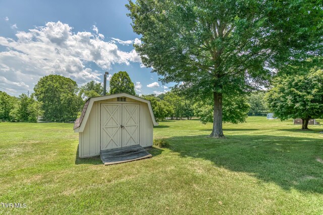 409 Brooklea Cir, Bluff City, TN 37618 - view of shed with view of wooded area