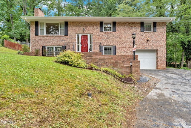 308 Cardinal Ln, Bristol, TN 37620 - split foyer home with a chimney, asphalt driveway, brick siding, and a garage