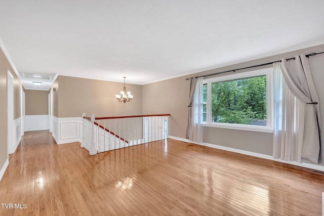 308 Cardinal Ln, Bristol, TN 37620 - unfurnished room with light wood-type flooring, crown molding, and a chandelier