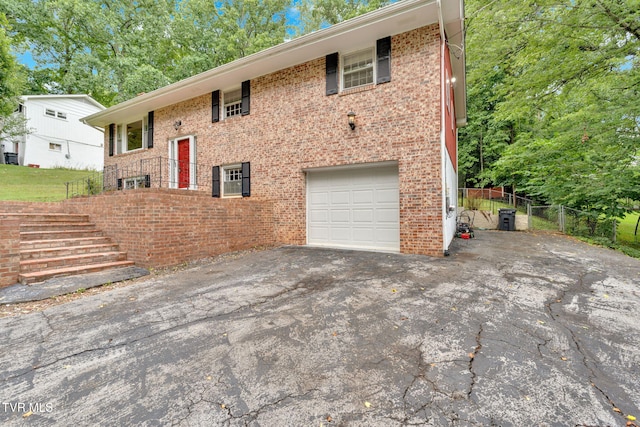 308 Cardinal Ln, Bristol, TN 37620 - bi-level home featuring an attached garage, driveway, brick siding, and stairs