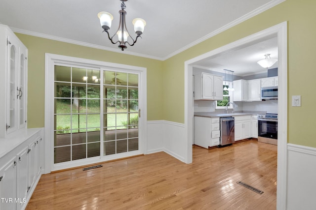 308 Cardinal Ln, Bristol, TN 37620 - kitchen with appliances with stainless steel finishes, a chandelier, white cabinetry, crown molding, and light wood-style flooring
