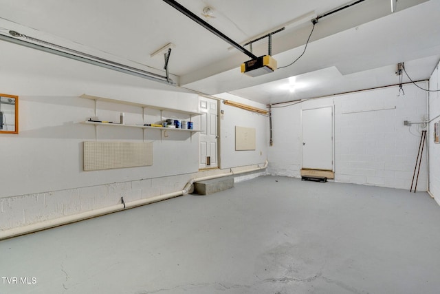 308 Cardinal Ln, Bristol, TN 37620 - garage featuring a garage door opener and concrete block wall