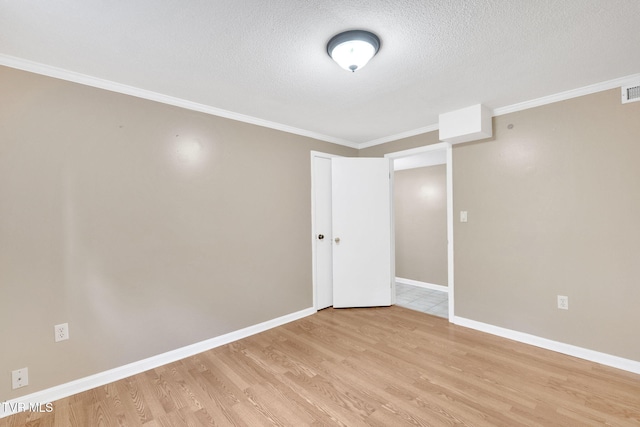 308 Cardinal Ln, Bristol, TN 37620 - unfurnished room with crown molding, light wood-type flooring, and a textured ceiling