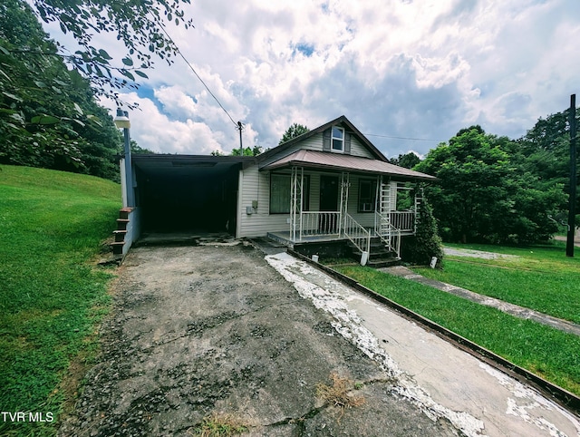2005 Dc Caney Ridge Rd, Clintwood, VA 24228 - view of front of home featuring driveway, a porch, an attached carport, and a front yard