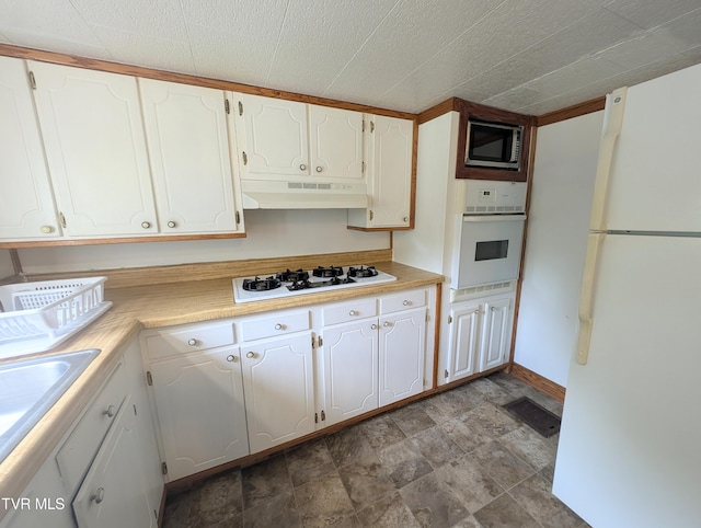 2005 Dc Caney Ridge Rd, Clintwood, VA 24228 - kitchen with white appliances, under cabinet range hood, white cabinets, and light countertops